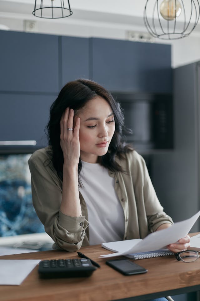 Woman studying documents of bank for credit check